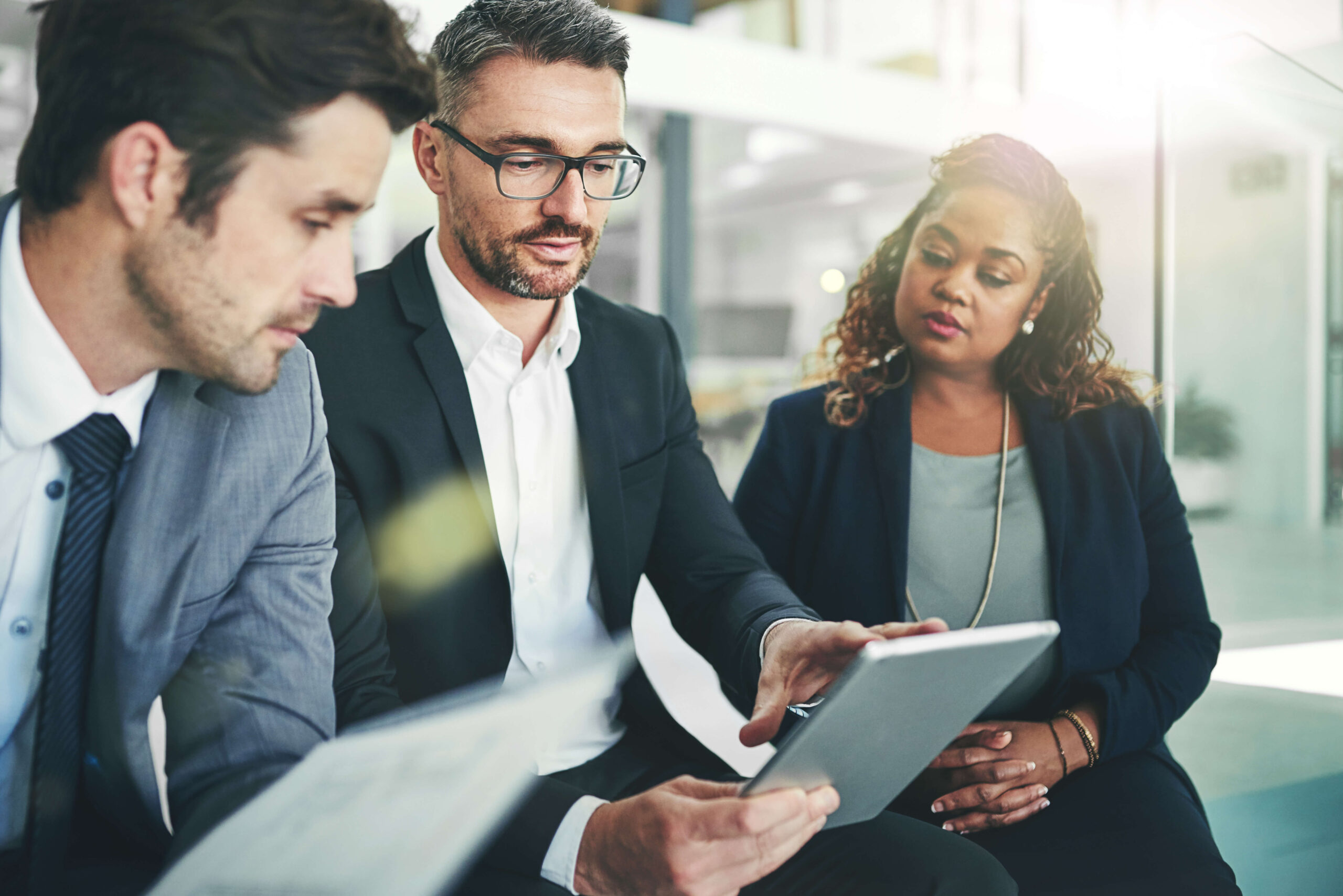 A group of coworkers talking together over documents