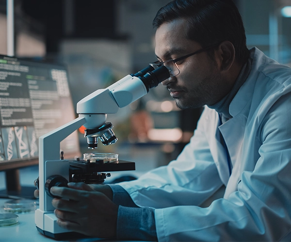 Male scientist using microscope